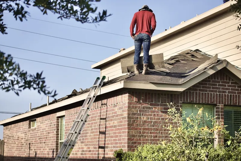 Professional roofer working on a residential roof in The Midwest Club